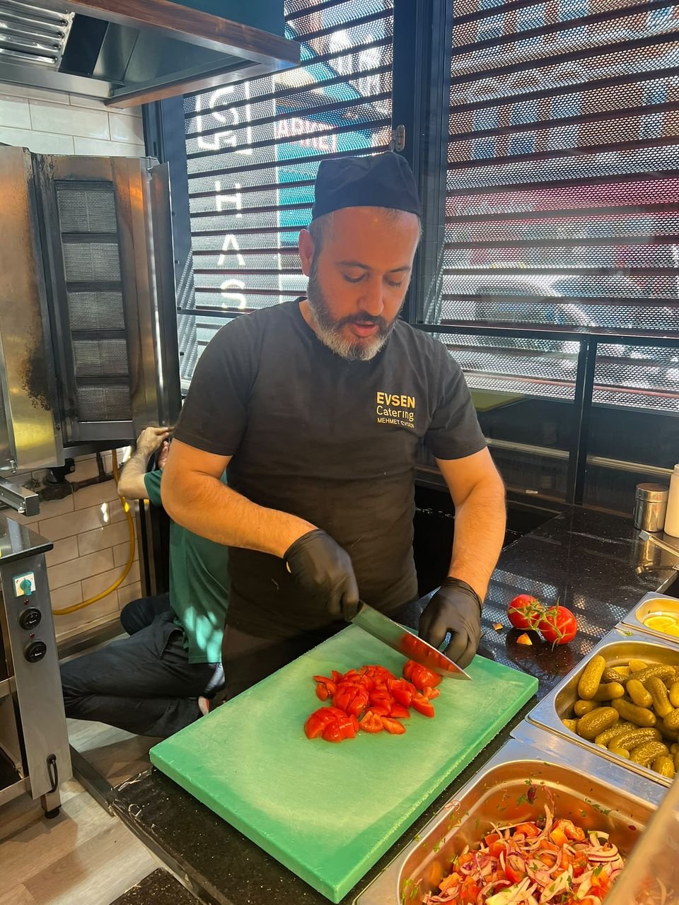 Chef chopping fresh tomatoes for salad